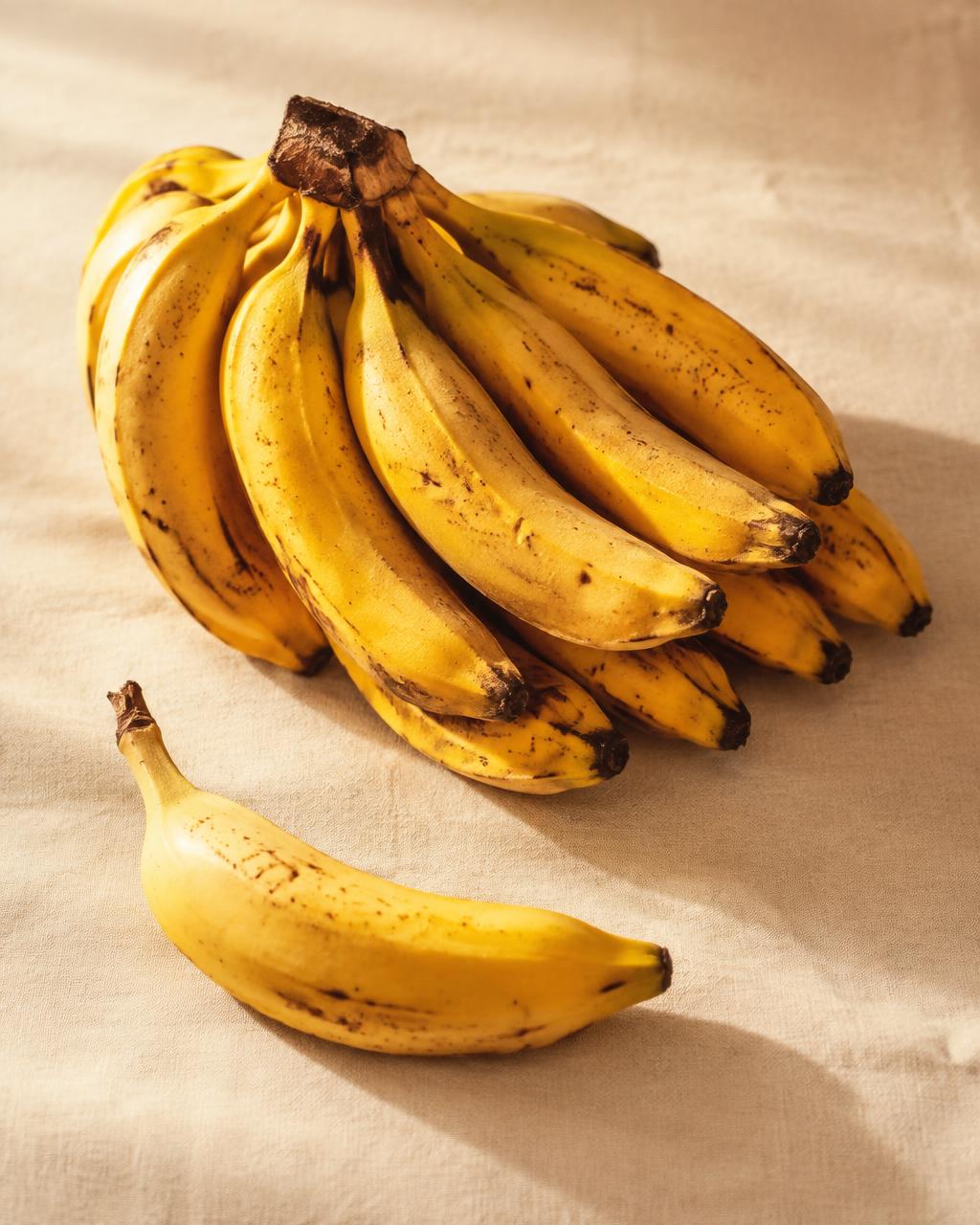 Ripe yellow bananas on cream linen